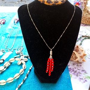 Matching red beaded necklace and earrings.